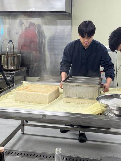 Pressing steamed rice into molds at Baekkyung Distillery